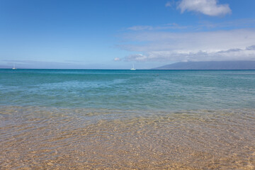 Wave on sand close up in tropical beach. Ocean water background 