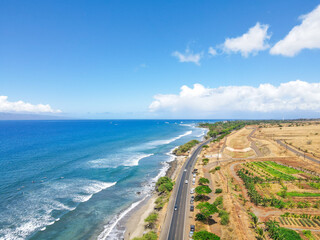 Aerial view of beach and ocean with waves in the island of Maui, Hawaii. Launiupoko State Beach during hot summer.