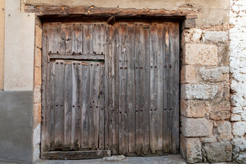 Large old wooden door in a Spanish village