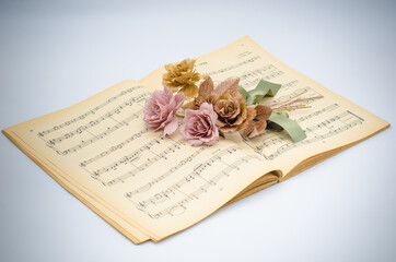 Naklejka na ściany i meble Paper flowers on musical note book