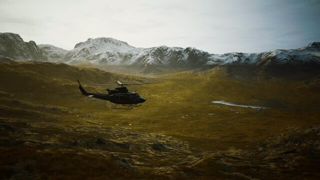 slow motion Vietnam War era helicopter in mountains