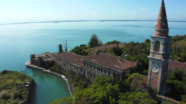 Aerial view of the plagued ghost island of Poveglia in the Venetian lagoon, opposite Malamocco along the Canal Orfano near Venice, Italy.