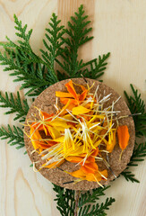 marigold petals on cork and cedar