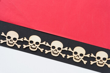 laser cut wooden shapes arranged in a row on a geometric paper background - halloween or pirate...