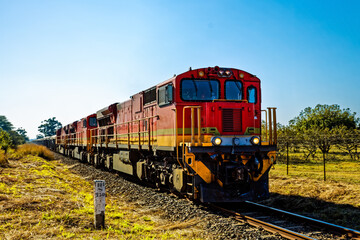 Red diesel electric locomotives pulling train