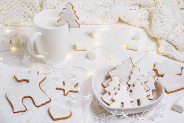 Christmas composition with gingerbread on a white textured surface, close-up view. Christmas celebration concept