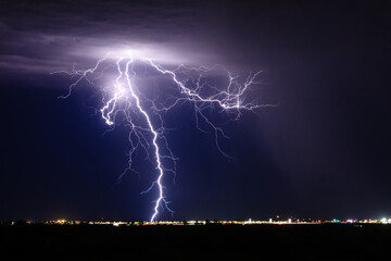 Lightning in the night sky over a city