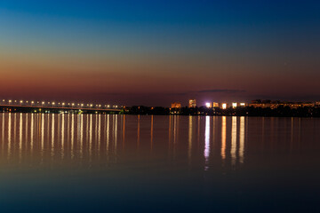Fototapeta na wymiar Night view of the Dnieper river and Dnipro city in Ukraine