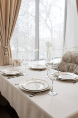 Beautifully set tables with glasses and plates in the restaurant 