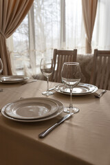 Beautifully set tables with glasses and plates in the restaurant 