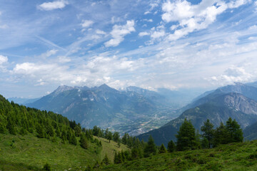 Panoramic view of relaxing mountain scenery with mountains in the background and meadow, grass on a nice, sunny day