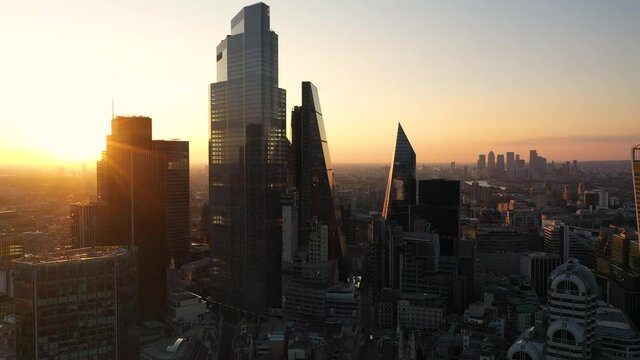 Skyline with tall skyscrapers against colourful sunrise sky