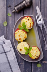 Stewed tomatoes stuffed with cheese