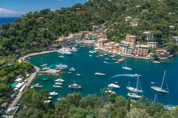 Landscaping overview of Portofino harbour with many yachts and ships, view from Castello Brown, Liguria, Italy