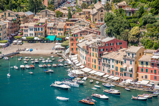 Panorama of Portofino seaside area with traditional colourful houses, harbour with numerous of yachts and ships, view from Castello Brown, Liguria, Italy