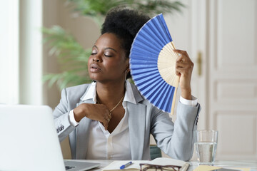 Overheated african mix raced businesswoman suffer from heatstroke working in office without air...
