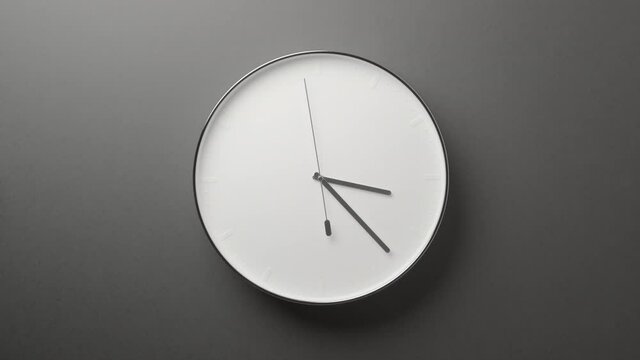 Clock Face on Dark Grey Office Wall in Timelapse