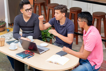 three students chatting in an open-air latin coffee shop. latin venue concept