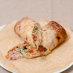 Vegetable shawarma with ham and fresh vegetables on a plate. Restaurant food concept 