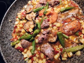 Bozbash - traditional food photo. Meat soup with vegetables defrosting on frying pan.