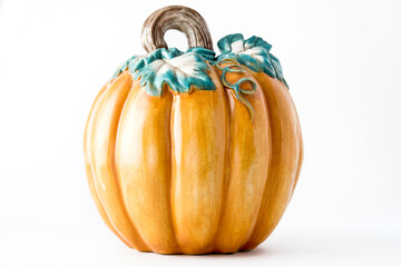 Decorative orange ceramic pumpkin isolated against white background. Thanksgiving concept