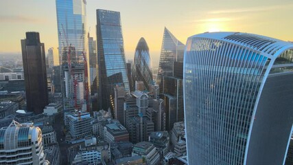 tall modern buildings against golden sunrise sky. Skyscrapers in City financial and economy centre. London, UK - Powered by Adobe
