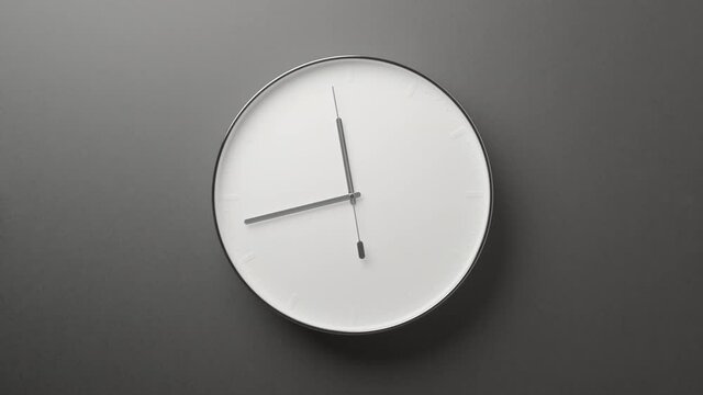 Clock Face on Dark Grey Office Wall in Timelapse