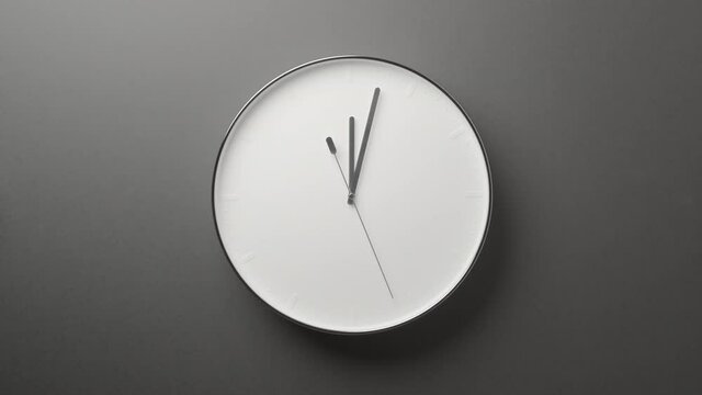 Clock Face on Dark Grey Office Wall in Timelapse