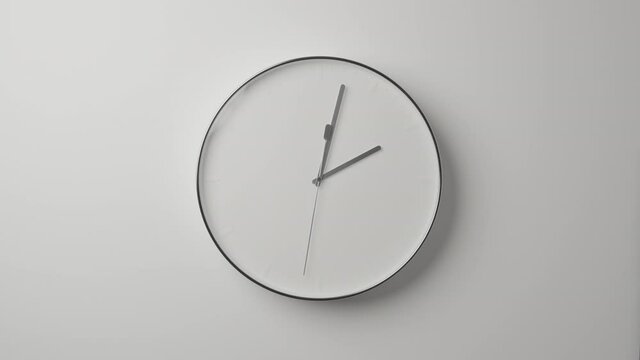 Clock Face on White Office Wall in Timelapse