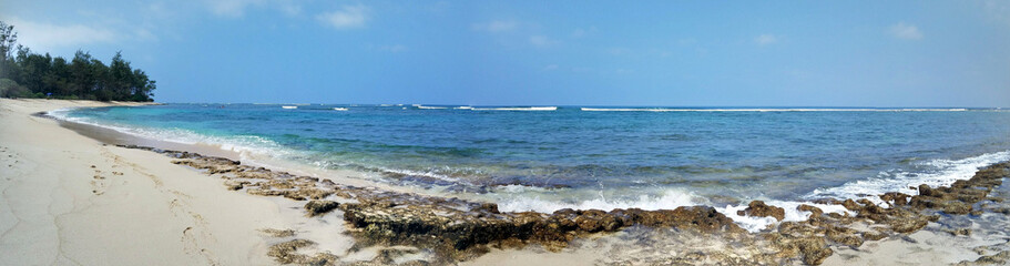 Panoramic of Coral Rock beach with Shallow wavy ocean waters of Camp Mokuleia Beach