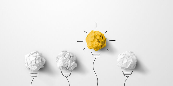 Concept creative idea and innovation. Paper scrap ball yellow colour outstanding different group with light bulb symbol