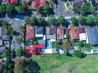 Fototapeta na wymiar Panoramic Aerial Drone view of Suburban Sydney housing, roof tops, the streets and the parks NSW Australia