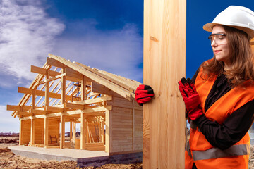 A builder next to timber frame. Wood construction concept. Unfinished frame house behind her. Woman...