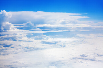 Fototapeta na wymiar White clouds on blue sky background view from above, airplane flight landscape, beautiful aerial cloudscape, skies backdrop, fluffy cloud texture, sunny heaven, cloudy weather, cloudiness, copy space