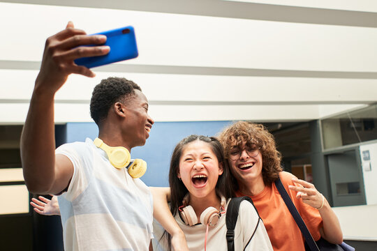 Multi-ethnic group of students taking a selfie at the college. Classmates having fun together.