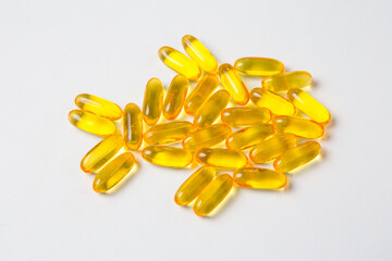 Fish oil capsule decorate in fish shape on white background.