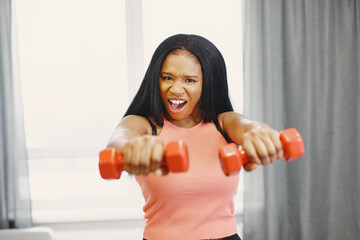 Afro American sportswoman working out at home