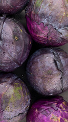 Red cabbage, colored dark red, purple leaves vegetable. Culinary, food styling, vegan or vegetarian, fresh veggie, healthy eating, colorful leafy vegetables concept. Vertical, top view image style.