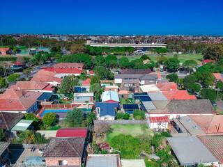 Fototapeta premium Panoramic Aerial Drone view of Suburban Sydney housing, roof tops, the streets and the parks NSW Australia