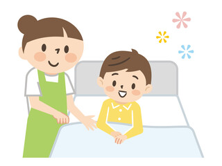 ベッドに横たわる男の子と介護する女性の介護士