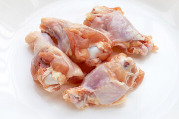 Fototapeta na wymiar Fresh raw chicken wings (wingstick) in white bowl