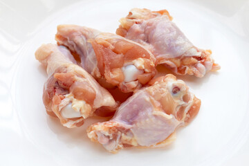Fresh raw chicken wings (wingstick) in white bowl
