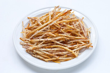 Fried taro sticks in white plate on white background.
