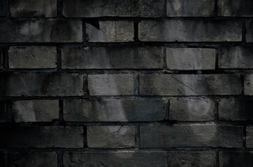 Background of a grungy brick wall stained with paint. Old brick wall texture backdrop.	