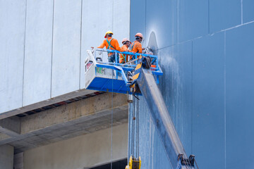 Crane with construction workers with real work