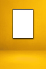 Black picture frame hanging on a yellow wall