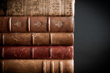 Stack of old books on black background