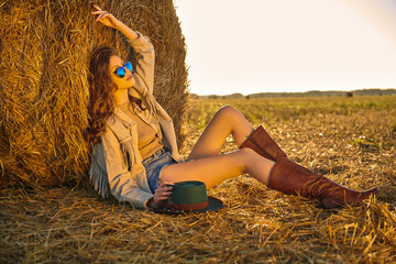 hippie girl by a haystack - obrazy, fototapety, plakaty