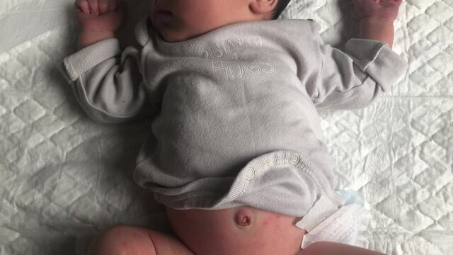 Calm newborn baby still with fresh navel