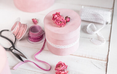 Beautiful pink round gift wrapping is decorated with narrowed roses. 